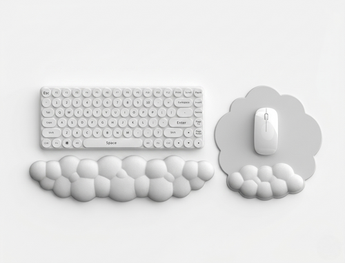White cloud-shaped keyboard wrist rest and matching cloud mouse pad with integrated wrist support on a clean white desk background.